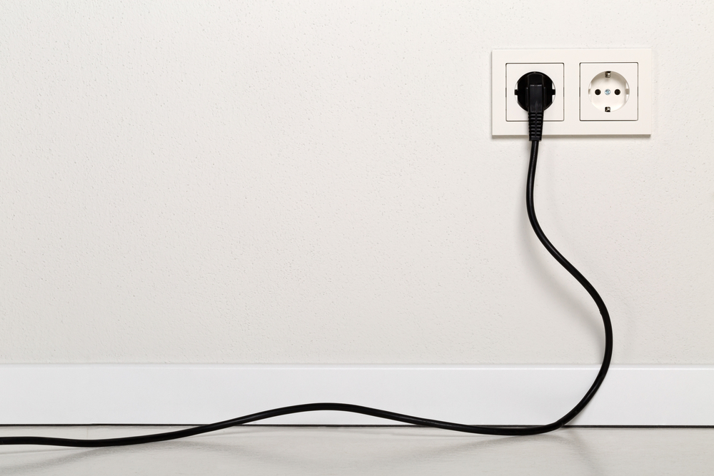 Why do some devices have plugs with two prongs, and others have three to work?
